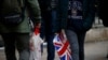 FILE - Shoppers carry shopping in plastic bags in the West End, in London, Britain, Dec. 27, 2018. 