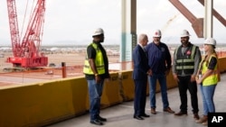 President Joe Biden tours the building site for a new computer chip plant for Taiwan Semiconductor Manufacturing Company, Dec. 6, 2022, in Phoenix, Arizona. 