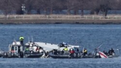 Emergency workers recover debris from the Potomac River in the aftermath of the collision of American Eagle flight 5342 and a Black Hawk helicopter, as seen from Virginia, Jan. 30, 2025. 