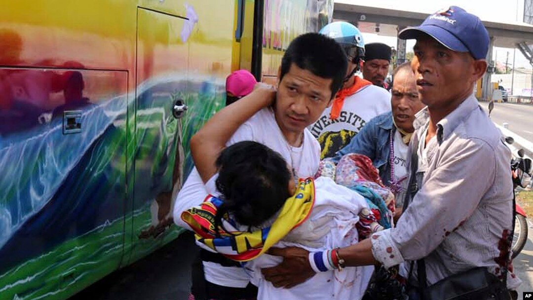 Demonstran anti-pemerintah Thailand membawa demonstran yang terluka dari bis ke ambulance pasca serangan kelompok bersenjata di Bangkok (1/4). 