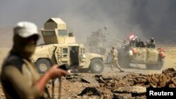 Members of Iraqi army are seen during the war between Iraqi army and Shi'ite Popular Mobilization Forces (PMF) against the Islamic State militants in al-Ayadiya, northwest of Tal Afar, Iraq, Aug. 28, 2017.