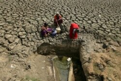 FILE - Women fetch water from an opening at a dried-up lake in Chennai, India. (Reuters)