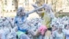 Students from St Andrews University are covered in foam as they leave after taking part in the traditional "Raisin Weekend" in the Lower College Lawn, at St Andrews in Scotland, Britain, October 21, 2024. 