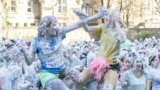 Students from St Andrews University are covered in foam as they leave after taking part in the traditional "Raisin Weekend" in the Lower College Lawn, at St Andrews in Scotland, Britain, October 21, 2024. 