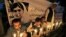 Pakistanis light candles in front of a banner showing a picture of 14-year-olschoolgirl Malala Yousufzai in Peshawar, Pakistan, Oct. 15, 2012. 
