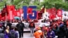 FILE - Cooks, cashiers and other minimum wage earners join anti-Trump activists on a march for an increase in the minimum wage during a “March on McDonald’s” in Chicago, Illinois, May 23, 2017. 