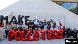Activists protest during COP28 in Dubai, United Arab Emirates, Dec. 10, 2023. Taiwan, with per capita emissions among the highest in the world, is blocked from participating in the summit. However, a Taiwanese official says Taiwan is willing to donate to a climate damage fund.