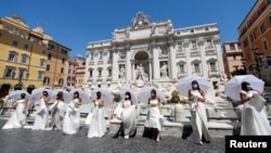Brides wearing wedding dresses hold a flash mob near Trevi fountain to protest against the postponement of their weddings due to the coronavirus disease (COVID-19) outbreak in Rome, Italy, July 7, 2020. 