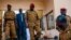 Burkina Faso Lt. Col. Issac Yacouba Zida, center, leaves a government building after meeting with political leaders in Ouagadougou, Burkina Faso, Nov. 4, 2014. 