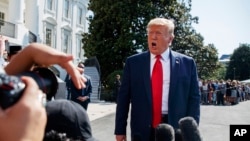 President Donald Trump talks to reporters on the South Lawn of the White House, Aug. 9, 2019, in Washington, as he prepares to leave Washington for his annual August holiday at his New Jersey golf club. 