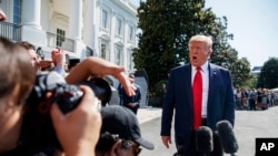 President Donald Trump talks to reporters on the South Lawn of the White House, Aug. 9, 2019.