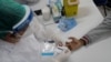 A health worker gives a resident a COVID-19 test on Vakcinacija u Brazilu