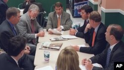 FILE - Lobbyist Brian Ballard, center meets with other lobbyists, from center to left, Mac Stipanovich, Gene McGee Joe McCann, Courtney Bense, Greg Turbeville, Matt Bryan, and Clark Smith in the Capitol cafeteria before the legislative session begins, Apr