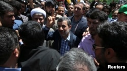 Former Iranian President Mahmoud Ahmadinejad (C) flashes a victory sign while attending the annual anti-Israeli Al-Quds, Jerusalem, Day rally in Tehran, Iran, June 8, 2018. 