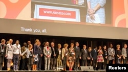 Delegates observe a minute's silence during the opening session, as a tribute to colleagues killed in the Malaysia Airlines flight MH17, at the 20th International AIDS Conference in Melbourne, July 20, 2014.