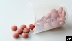 FILE - Ibuprofen pills.