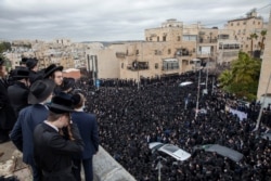 Thousands of ultra-Orthodox Jews participate in funeral for prominent rabbi Meshulam Soloveitchik, in Jerusalem, Jan. 31, 2021.