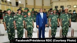 File -President Felix Tshisekedi standing with members of the national army, Kinshasa, July 11, 2020. 