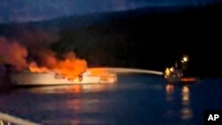 Photo provided by the Santa Barbara County Fire Department shows firefighters working to extinguish a dive boat after a deadly fire broke out aboard the commercial scuba diving vessel off the Southern California Coast, Sept. 2, 2019.