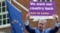 FILE - Nigel Farage, a British politician and leader of the UKIP party, holds up a placard as he launches his party's campaign for Britain to leave the European Union, outside the EU representative office in London, May, 20, 2016.