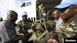 The bodies of the United Nations peacekeepers killed in western Ivory coast near the Liberia border arrive in Abidjan June 9, 2012. 