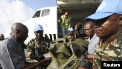 The bodies of the United Nations peacekeepers killed in western Ivory coast near the Liberia border arrive in Abidjan June 9, 2012. 