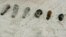 FILE - Some of the more than 1,100 old fuses and small anti-aircraft shells that have been found along the Atlantic Ocean in Surf City, N.J., Feb 10, 2009.