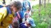 Teacher Laura Peterson and her students examine a stream during Hike Day.