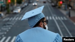 A graduating Masters student from the Columbia University Graduate School of Architecture, Planning and Preservation (GSAPP) stands on campus the day before his graduation ceremony, which is to be held online due to the outbreak of the coronavirus.