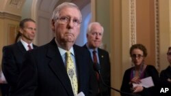 Senate Majority Leader Mitch McConnell, R-Ky., joined from left by Sen. John Thune, R-S.D., and Majority Whip John Cornyn, R-Texas, speaks to reporters on Capitol Hill in Washington, April 17, 2018.