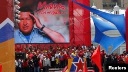 Venezuela's acting President Nicolas Maduro (center) talks to supporters after registering as a candidate for president in the April 14 election outside the national election board in Caracas on March 11, 2013. 