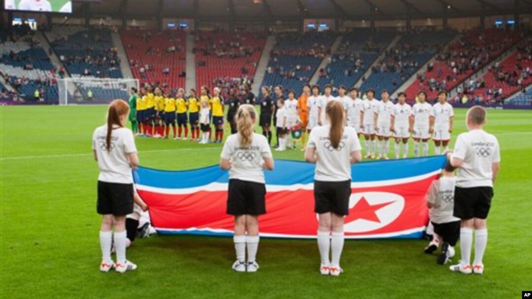 Tim sepakbola putri Korea Utara menyanyikan lagu kebangsaan mereka sebelum pertandingan grup C antara Kolombia melawan Korea Utara yang menandai dimulainya pertandingan Olimpiade Musim Panaas London 2012 di stadion Hampden Park, Glasgow (25/7).