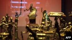 FILE - This photo shows the Ato ceremony of the Kingdom of Dahomey, circa 1934, on May 18, 2018, at the Quai Branly Museum-Jacques Chirac in Paris. Experts have advised President Emmanuel Macron to allow the return of thousands of African artworks held in French museums.