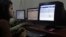 FILE - A girl surfs a Facebook page at an Internet cafe in Gauhati, India.
