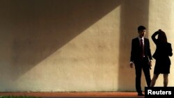 Office workers take cigarette break in the morning light, central business district, Singapore, Oct. 28, 2013.