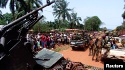 Armed fighters from the Seleka rebel alliance patrol the streets in pickup trucks to stop looting in Bangui, March 2013.