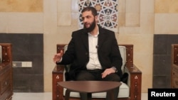 FILE - Syria's de facto leader, Ahmed al-Sharaa, speaks in Damascus in this handout image released Dec. 21, 2024. (Hayat Tahrir Al-Sham/Handout via Reuters)