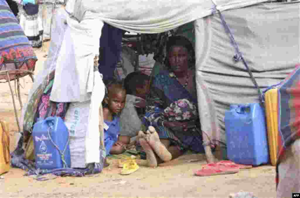 A Somali woman from southern Somalia and her children rest in their makeshift shelter at a camp for displace people in Mogadishu, Somalia, Saturday, Aug, 6, 2011. The United Nations says famine will probably spread to all of southern Somalia within a 