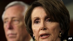 U.S. House Minority Leader Rep. Nancy Pelosi (R) speaks as House Minority Whip Steny Hoyer (L) listens during a news conference on Capitol Hill in Washington, DC, December 16, 2011.