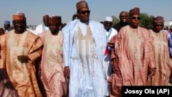 FILE - Nigerian presidential candidate Muhammadu Buhari, center, from the All Progressives Congress (APC) party arrives for a party rally in Maiduguri, Nigeria, Feb. 16, 2015. 