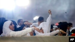 Muslim pilgrims cast stones at a pillar symbolizing the stoning of Satan, in a ritual called "Jamarat," the last rite of the annual Hajj, on the first day of Eid al-Adha, in Mina near the holy city of Mecca, Saudi Arabia, Aug. 11, 2019.