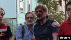 An injured man walks with paramedics after he was rescued from a residential building damaged during a Russian drone and missile strike in Lviv, Ukraine Sept. 4, 2024.