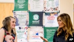 First lady Melania Trump, right, meets with Megan Pawley, a mother in recovery, and her baby at Cabell-Huntington Health Center in Huntington, West Virginia, July 8, 2019.