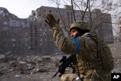 FILE - A Ukrainian serviceman guards his position in Mariupol, Ukraine, on March 12, 2022. The image is part of the documentary film "20 Days in Mariupol," which has been nominated for an Academy Award in the category of best documentary.