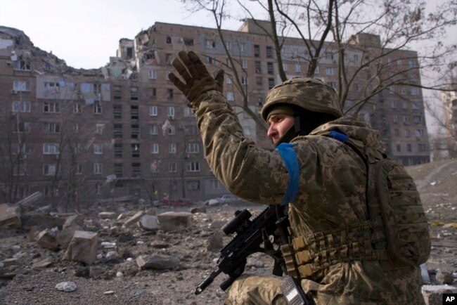 FILE - A Ukrainian serviceman guards his position in Mariupol, Ukraine, on March 12, 2022. The image is part of the documentary film