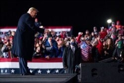 President Donald Trump points at the crowd after a campaign rally at Erie International Airport, Tom Ridge Field, Tuesday, Oct. 20, 2020, in Erie, Pa.