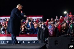 President Donald Trump points at the crowd after a campaign rally at Erie International Airport, Tom Ridge Field, Tuesday, Oct. 20, 2020, in Erie, Pa.