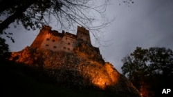 FILE - Bran Castle lies on top of cliffs in Bran, Romania, Oct. 9, 2016. Authorities have closed a 13th-century fortress connected to Vlad the Impaler after a mother bear and her cubs were found roaming in the area.