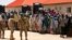 Security officers are called to control some of the internally displaced people at the Bakkasi camp. The people were upset at camp authorities for what they say is poor distribution of food rations, in Borno, Nigeria, on August 29, 2016.