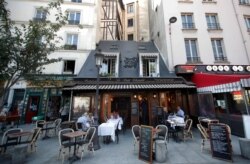 People eat lunch at a deserted Le Petit Chatelet restaurant in the Quartier Latin as the country battles to contain the coronavirus disease (COVID-19) while ensuring that economic and social activities can continue, in Paris, Sept. 18, 2020.